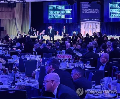 (LEAD) Trump evacuated from White House correspondents' dinner; alleged shooter in detention