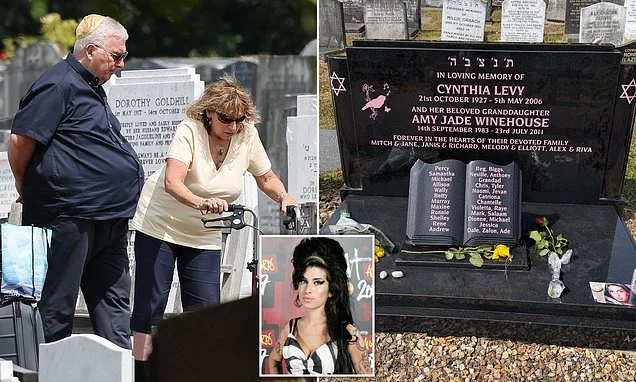 Amy Winehouse's parents Mitch and Janis visit the singer's grave to pay their respects on the 15th anniversary of her death