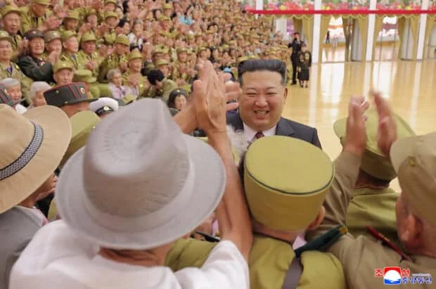 Kim Jong Un joins war veterans for 'Victory Day' photos