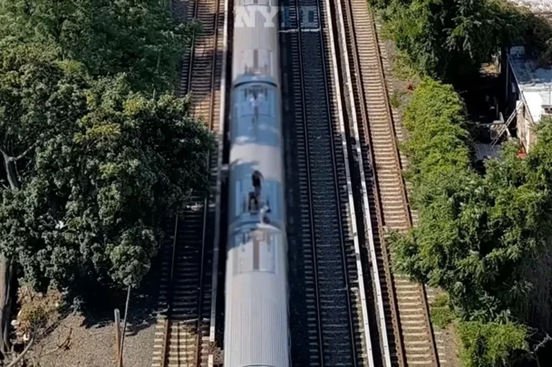 Teenage subway surfers filmed running along top of cars are tracked down by NYPD drones