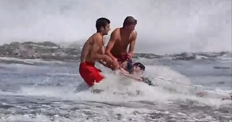 Pair of lifeguards keep young swimmer from being swept out to sea in California