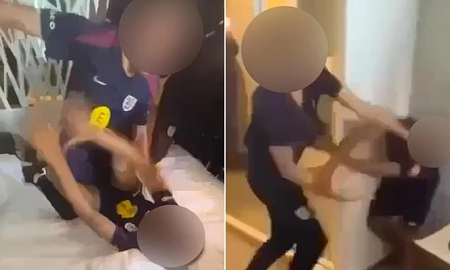 Shocking moment England youth stars scrap in wild hotel brawl as team-mates stand around laughing and recording on their phones instead of breaking up fight