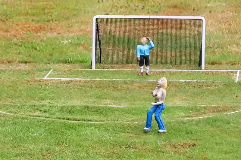Model village removes topless streaker from football pitch after families complain