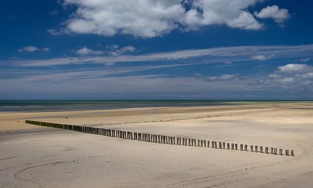 British police hunt small boat migrants who crossed Channel after man in his 20s was 'murdered' on French beach