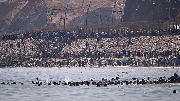 Thousands of migrants storm Ceuta border from Morocco