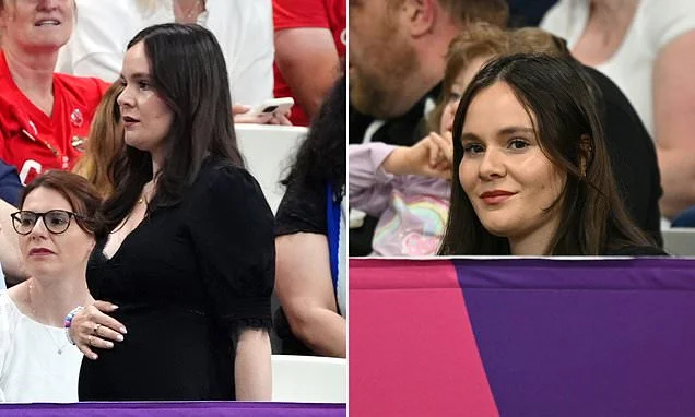 Pregnant Holly Ramsay cradles her baby bump as she anxiously waits in the stands to watch husband Adam compete in 50m breaststroke final at the Commonwealth Games