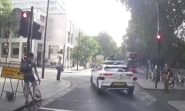 Moment 'self-driving' Waymo stops at a green light then 'runs a red'... but is it in the wrong?