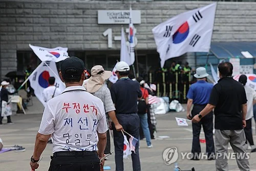Olympic committee mulling legal action against protesters, election body in ballot-shortage controversy