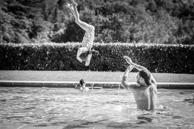 Prince Harry throws daughter Lilibet in swimming pool in newly released family holiday photos