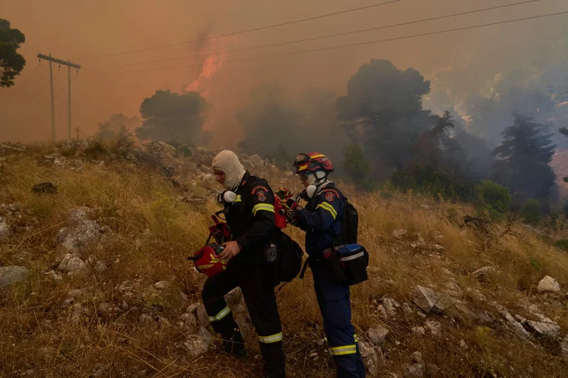 Firefighters scramble to contain fires outside Athens before winds and high temperatures return