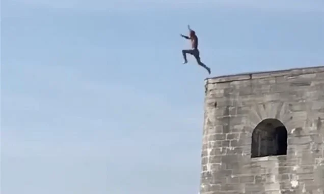 Moment daredevils are caught tombstoning into shallow water as they run and jump off 20ft high sea walls