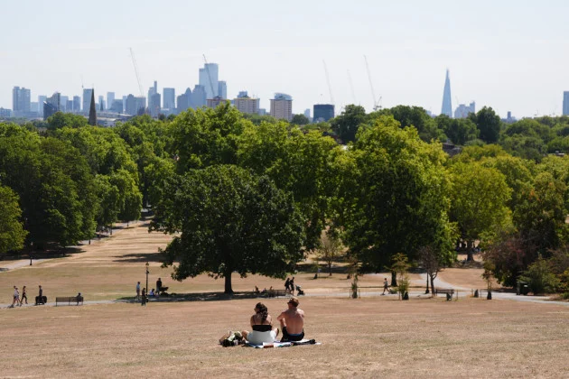 Temperatures rise to 30C in the UK, while Scotland is hit by half a month’s rain in two days