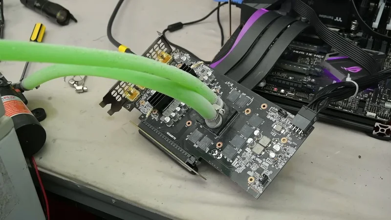 Modder pumps liquid directly over bare GPU silicon via 3D-printed block — drops RTX 2060 Super load temps to 28°C despite initial leaks