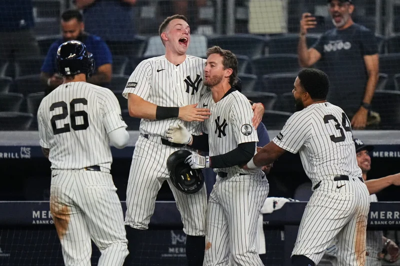 Yankees rally with 2 outs in 9th inning and beat Braves 3-2 in 10 after long rain delay