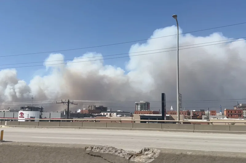 Residents flee fast-moving Washington wildfire as officials investigate what started it