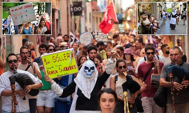 Thousands of anti-tourism protesters take to the streets of Majorca, with some waving anti-English banners