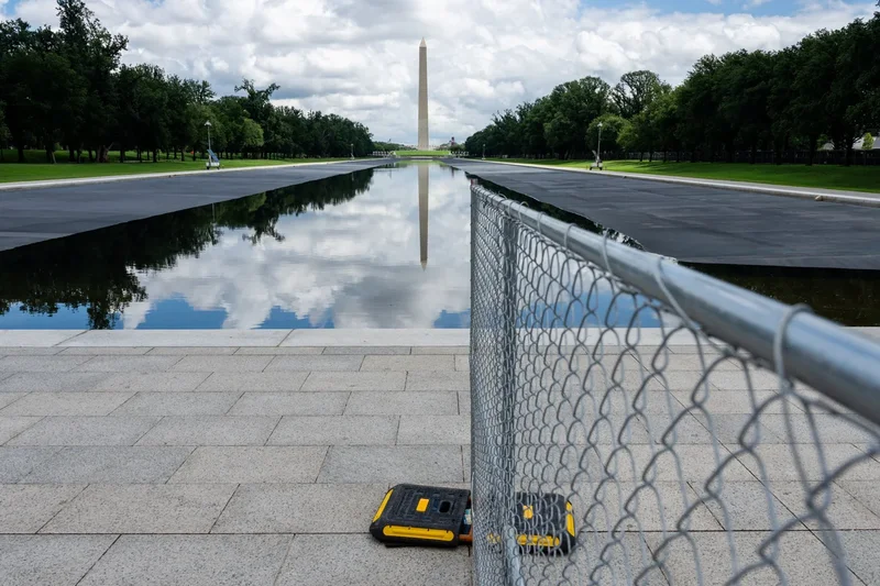 Fencing remains up around the Reflecting Pool despite admission that vandals didn’t cause the damage