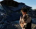 Japan’s prime minister tours quake-hit sites as recovery efforts hampered by soaring temperatures