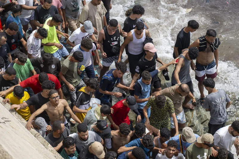 Spain installs floating barrier in North African enclave following border rush by tens of thousands