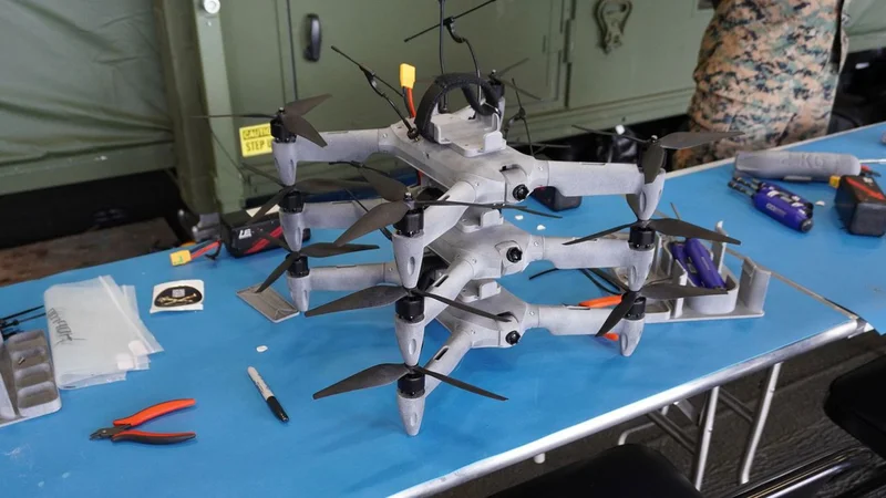 US Navy 3D prints combat-ready drones and 1,000+ parts aboard aircraft carrier during exercise — containerized factory fabricated 80-mph FPVs and critical spares despite rough seas and 12-foot waves