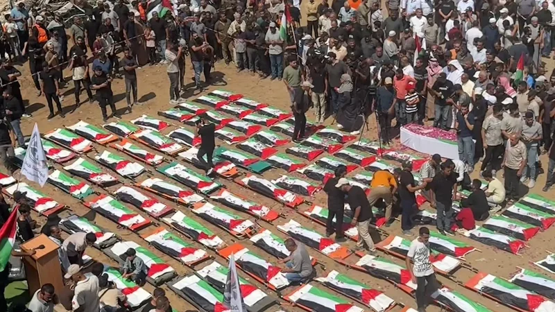 Mass funeral held for 112 members of two Palestinian families