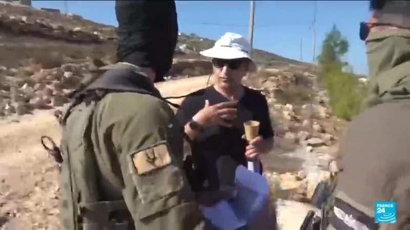 Palestinian American challenges Israeli army outside his home in the West Bank