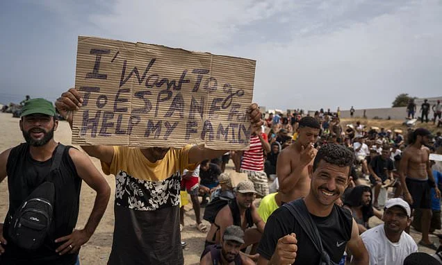 Hundreds of Ceuta migrants stage protest demanding Spain asylum after being left sleeping on beach following 'invasion' - as medics fight disease outbreaks