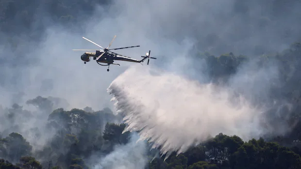 Water-dropping aircraft battle major wildfire in Greece after crash kills 2