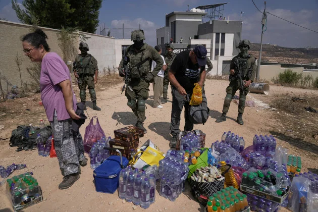 Activists try to deliver supplies to Palestinians besieged by Israeli settlers in West Bank
