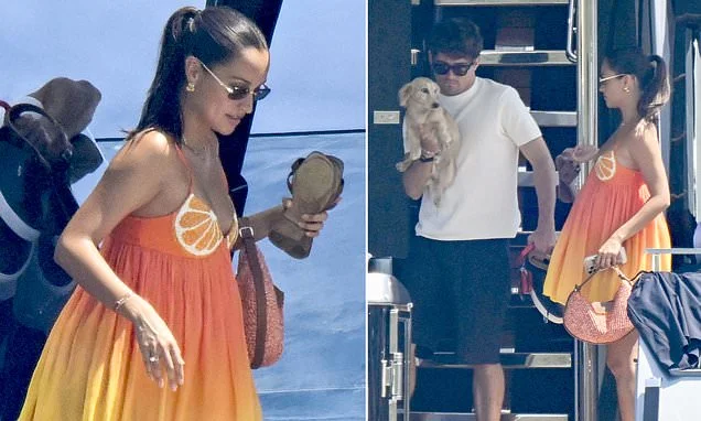 Charles Leclerc's wife Alexandra shows off her 'baby bump' in a £477 citrus mini dress as she joins him and their miniature dachshund Leo on board £15million yacht in Sardinia