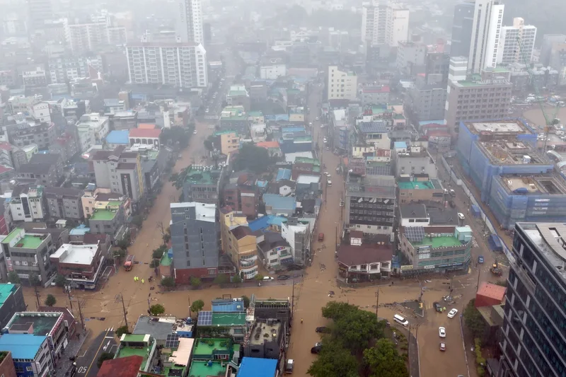 Heavy rains kill 1 in South Korea and flood major streets in Philippines