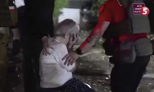 A grandmother's tragedy: Heartbroken Ukrainian looks on as her grandson's body is pulled from rubble after Russian missile hits apartment block
