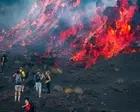 Hikers gather as red-hot lava pours from Mount Etna - video