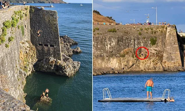 Moment reckless 'tombstoning' youths leap off 65ft cliff and into water at notorious Dead Man's Cove