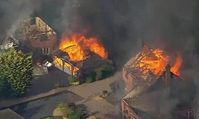 'Ash has been raining down on us from the sky for hours': On the hottest day of the year, rampant wildfires engulf streets of family homes across the country