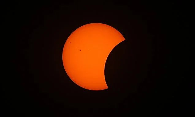 Solar eclipse in pictures: Stunning snaps show the moment the moon covered the face of the sun