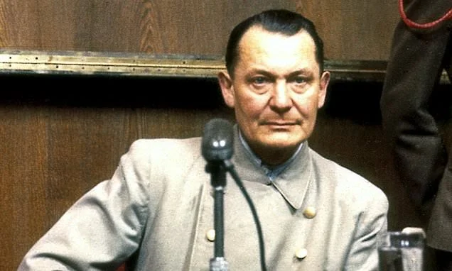 Is this the smirk that proves who handed Herman Goering a cyanide pill so he didn't face the gallows? Eighty years on, a new book uncovers how the Nazi monster's suicide could have been aided by two BRITISH soldiers