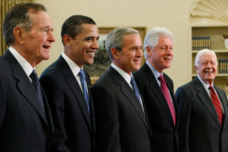 Trump goes unmentioned but not ignored as Clinton, Bush and Obama step up as essayists on presidents