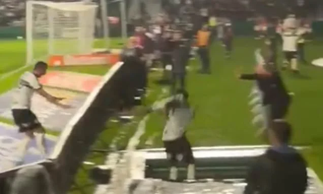 Horrifying moment footballer plummets down a hole in the ground while celebrating a goal... only for it to be ruled out for offside!